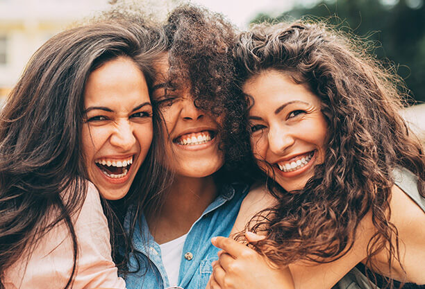 three smiling friends