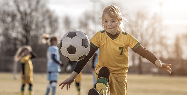 girl playing soccer