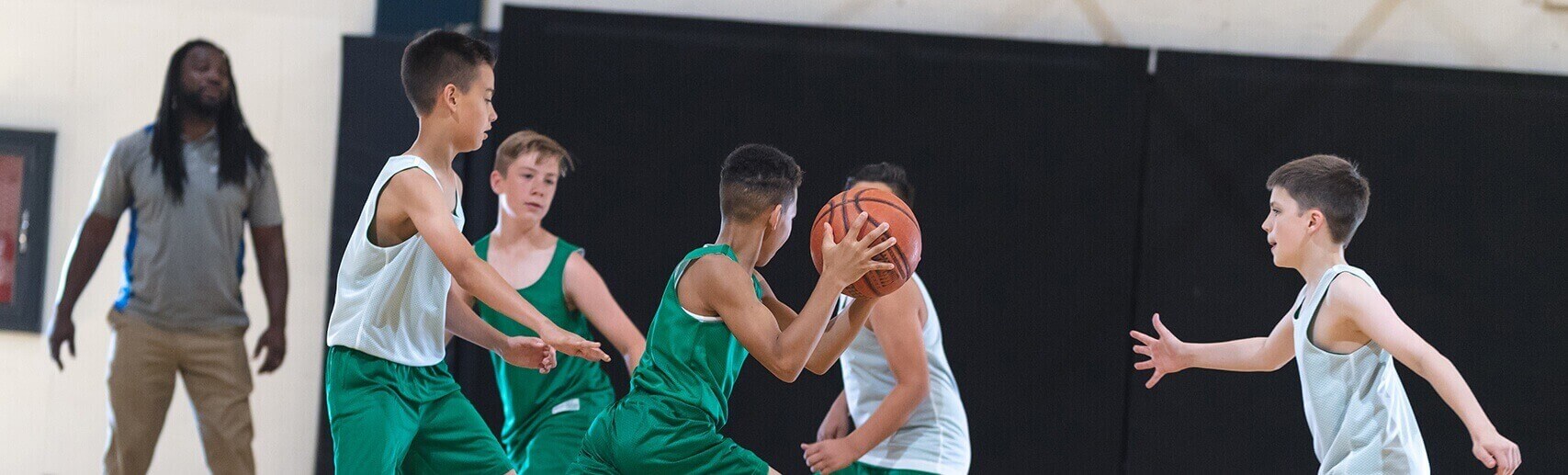 Young boys playing basketball in a gym