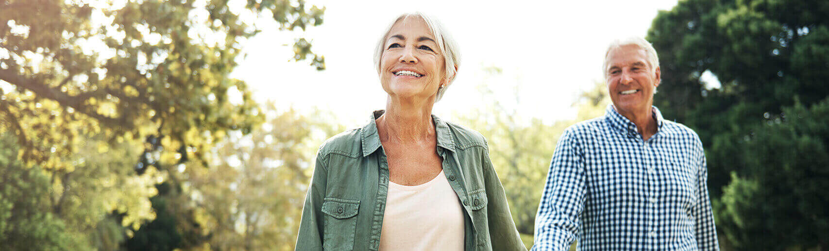 Older couple smiling while walking outside