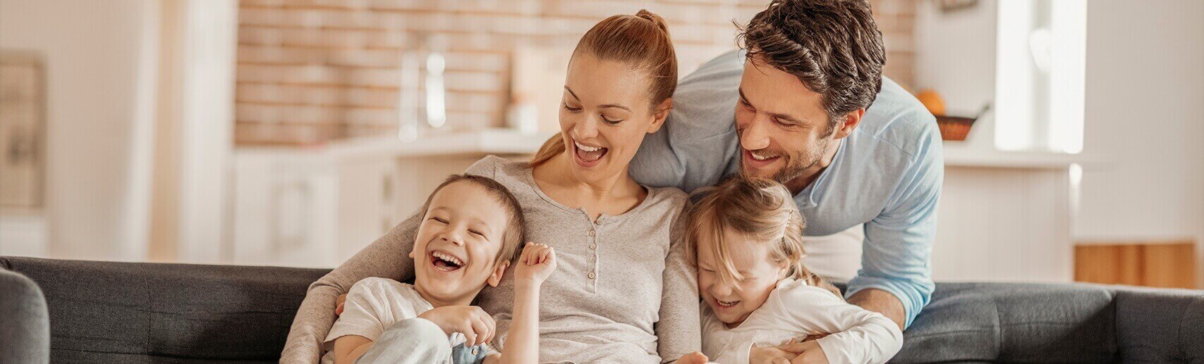 Family laughing on a couch