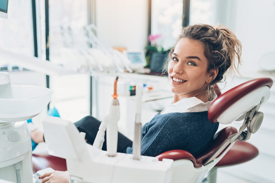 Brunette woman smiles before root canal therapy in Rose City Park, OR