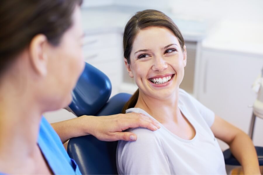 Brunette woman smiles at the dentist in Portland, OR