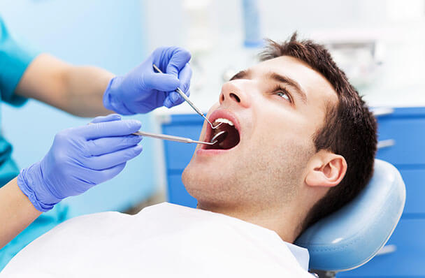 a young man getting a dental exam