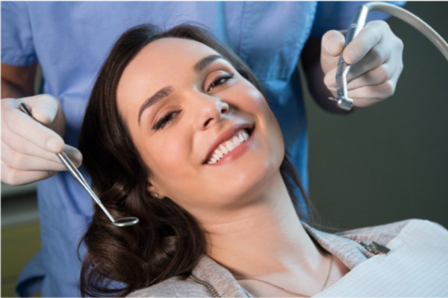young woman in the dentist's chair getting a dental exam