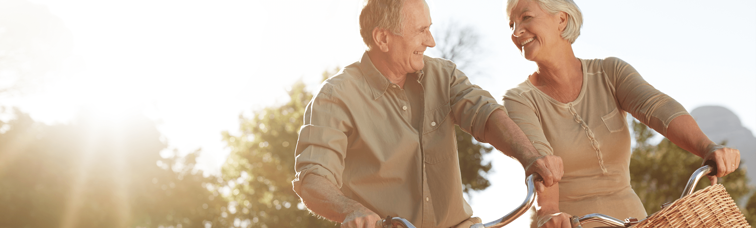 older man and woman riding bikes