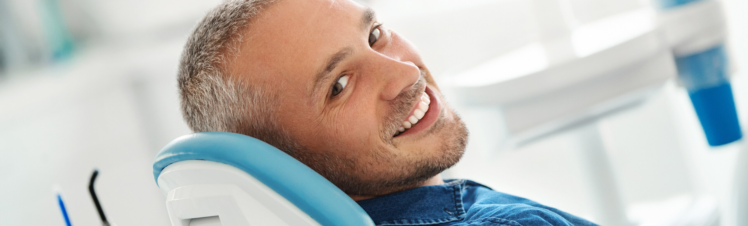 man sitting in dental chair