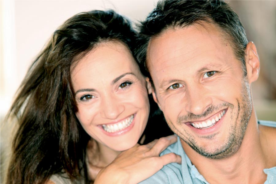 couple smile showing off their porcelain veneer smiles
